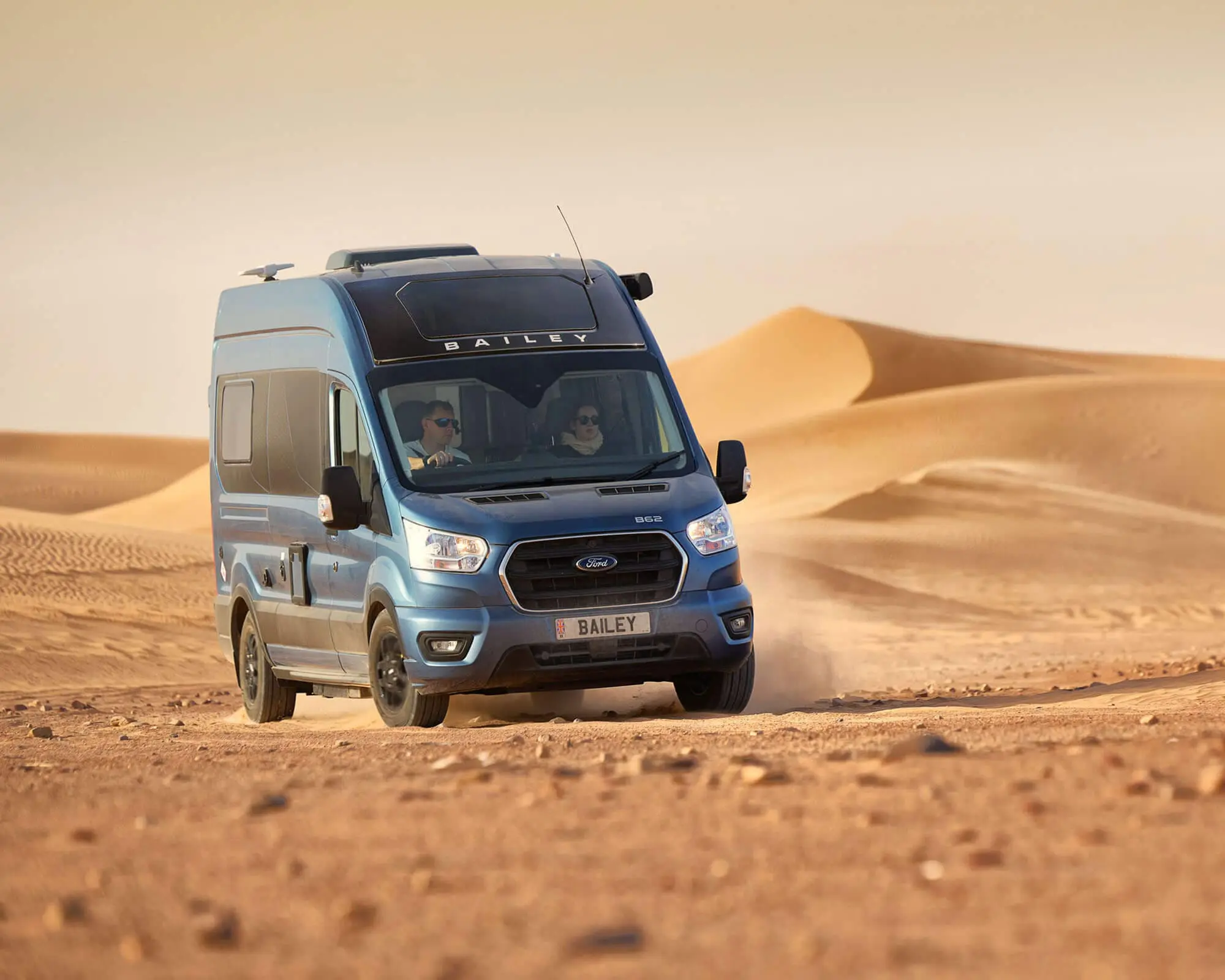 A Bailey motorhome navigating sandy desert dunes.