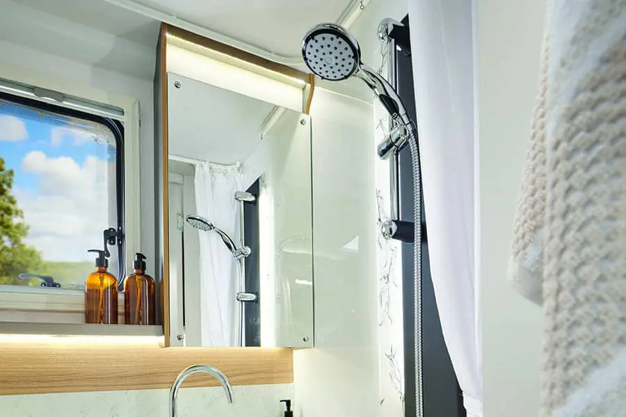 Luxury Bathroom Feature in a Bailey Caravan Interior view of a modern bathroom in a Bailey caravan, showcasing a showerhead, mirror, and stylish fixtures.