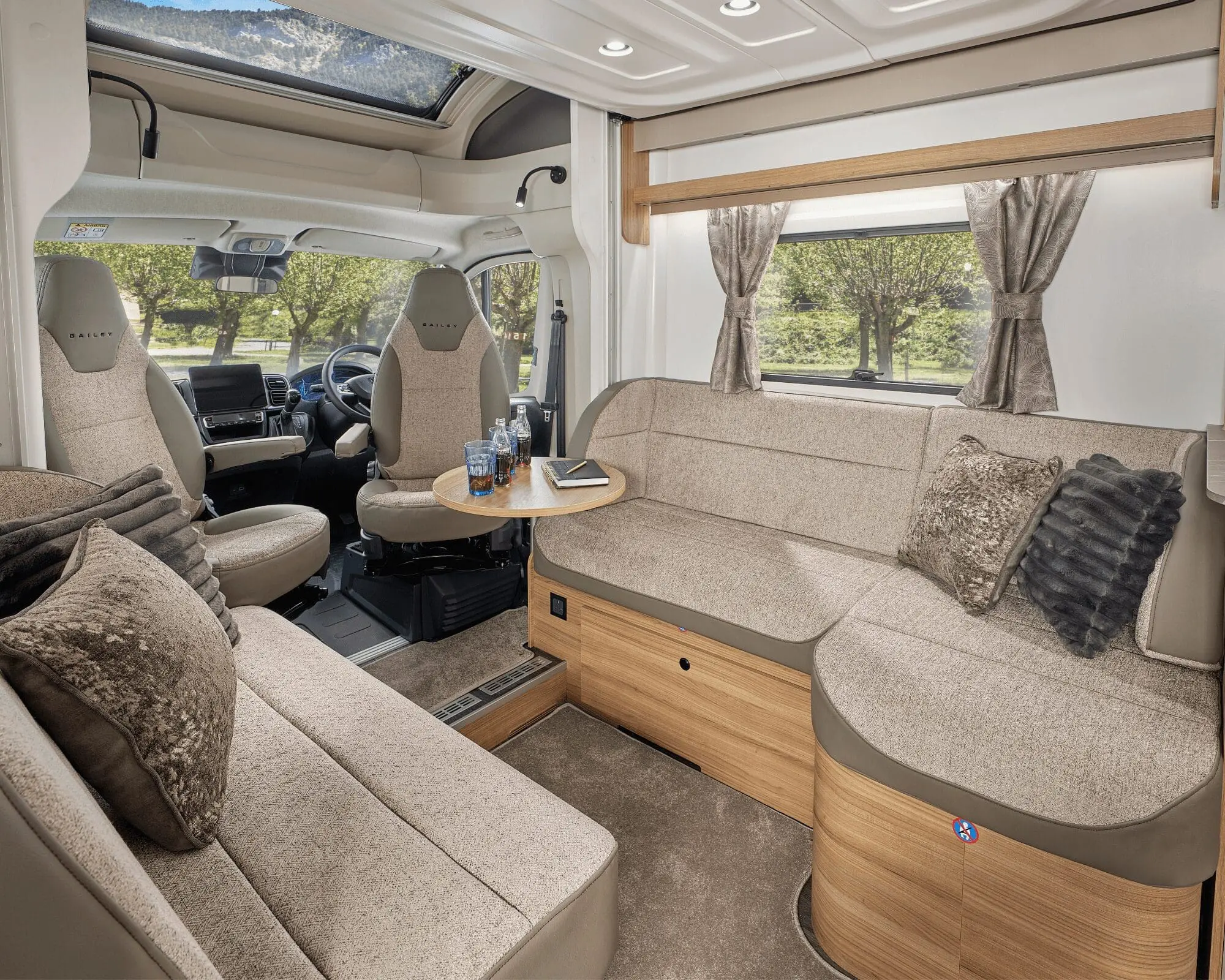 Spacious and stylish seating area inside a modern Bailey motorhome featuring comfortable upholstery and a cozy atmosphere.