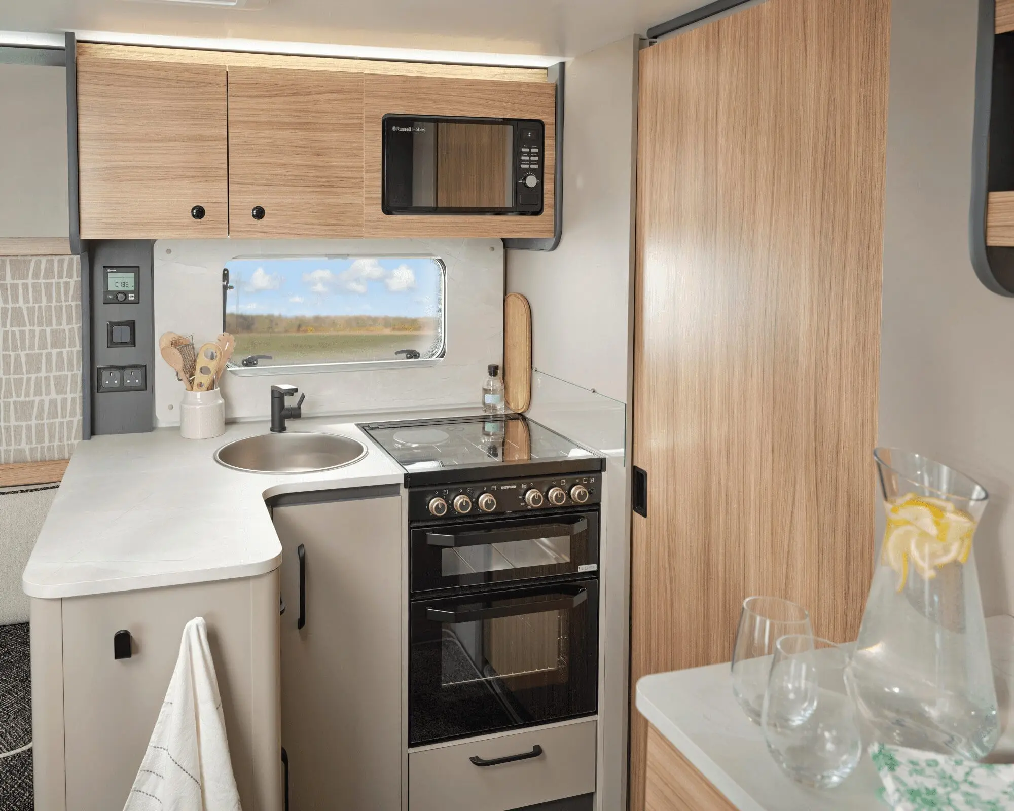 Modern Kitchen Interior of a Bailey Motorhome Stylish kitchen area in a Bailey motorhome featuring a stove, microwave, and ample storage.