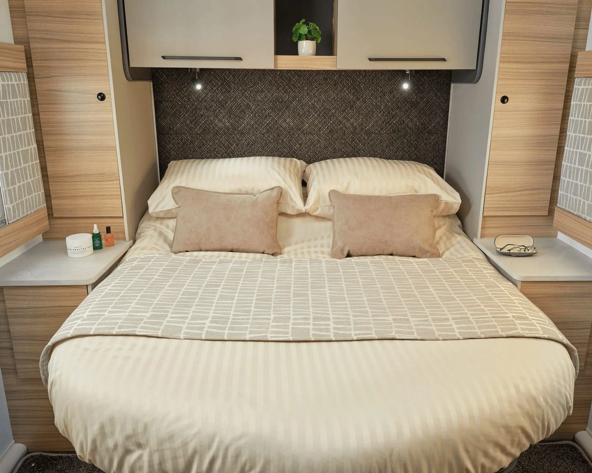 Cozy Interior of a Bailey Caravan Bedroom Elegant bedding arrangement in a Bailey caravan with soft pillows and ambient lighting