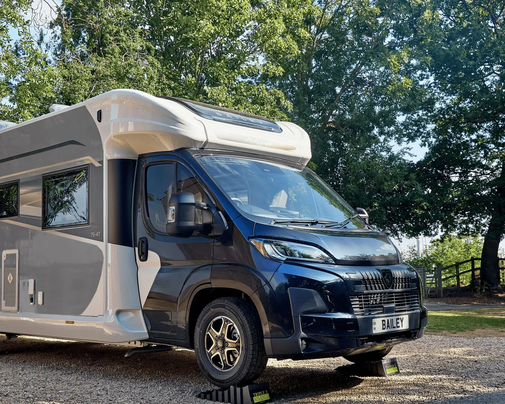 A modern Bailey motorhome parked in a green outdoor area, showcasing its sleek design and features.
