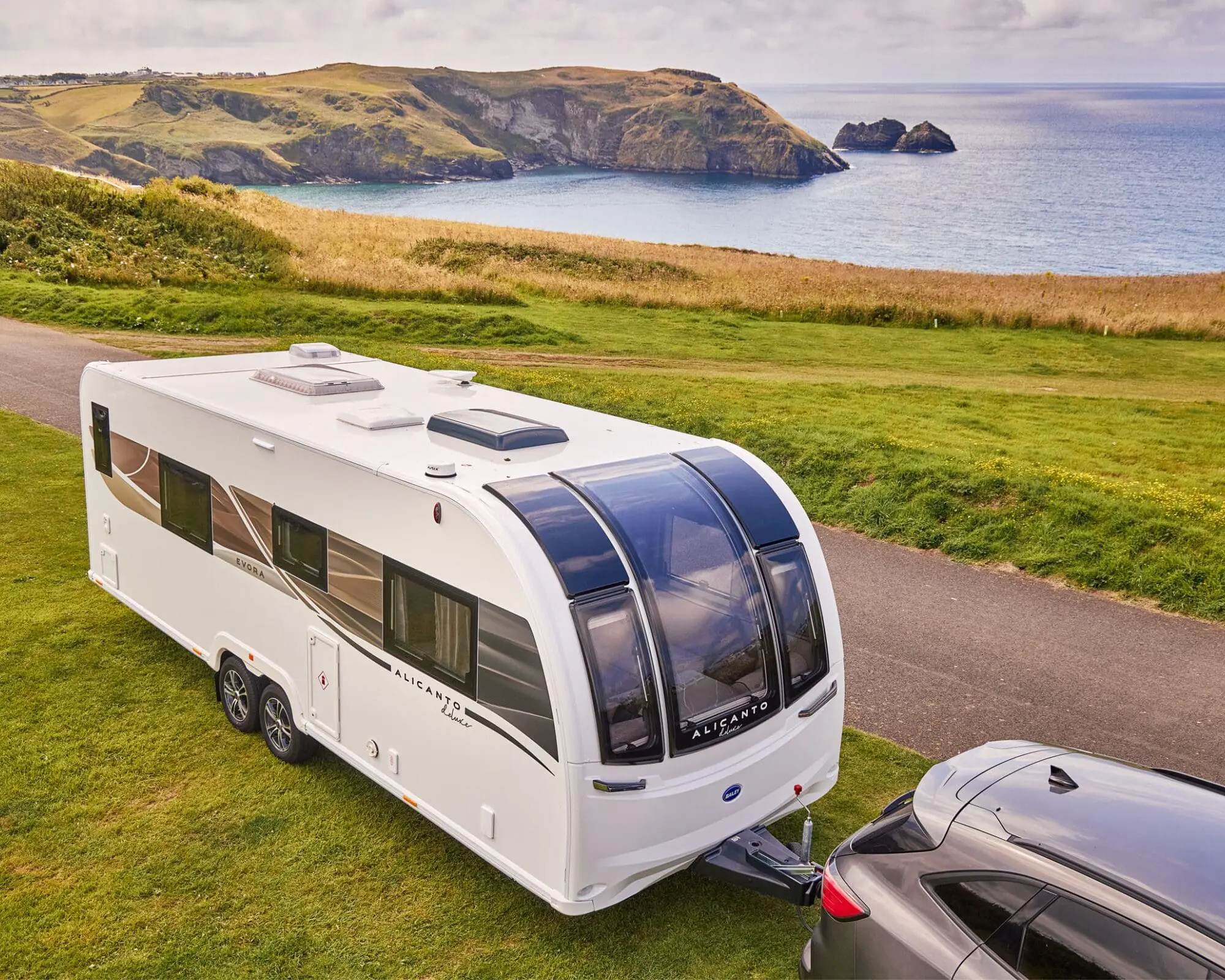 Stylish Bailey Caravan by the Coast A modern Bailey caravan parked near a beautiful coastline, showcasing its sleek design and scenic surroundings.