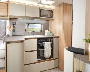 Well-equipped kitchen in a Bailey caravan with modern appliances and wooden finishes.
