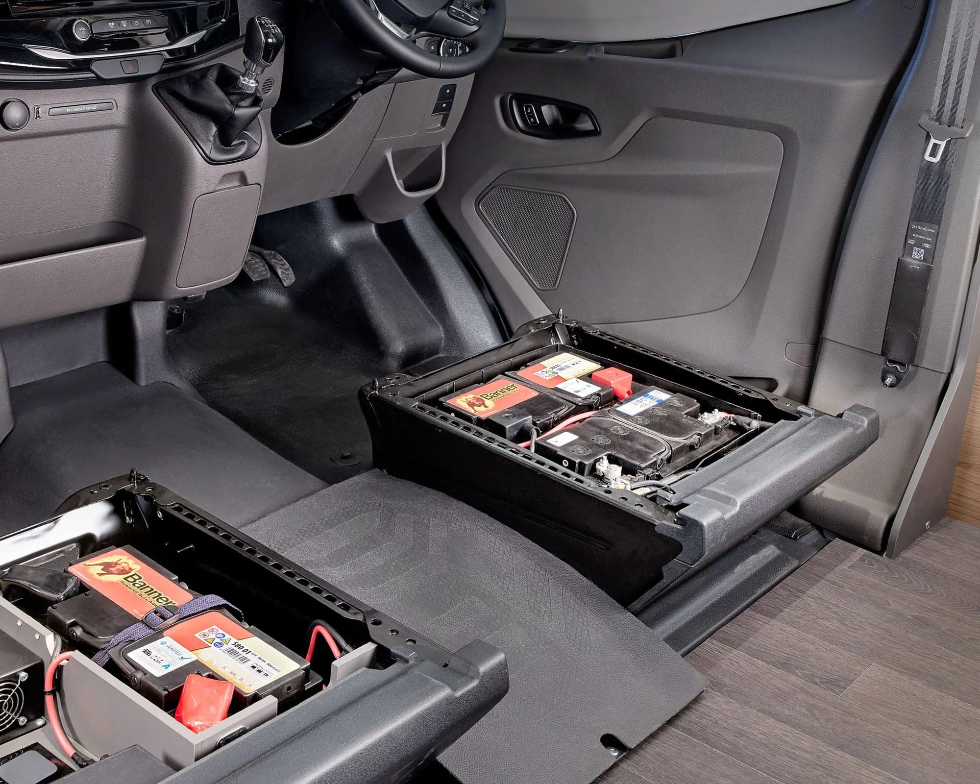 Image showing battery compartments in the interior of a vehicle, suitable for motorhomes and campervans.