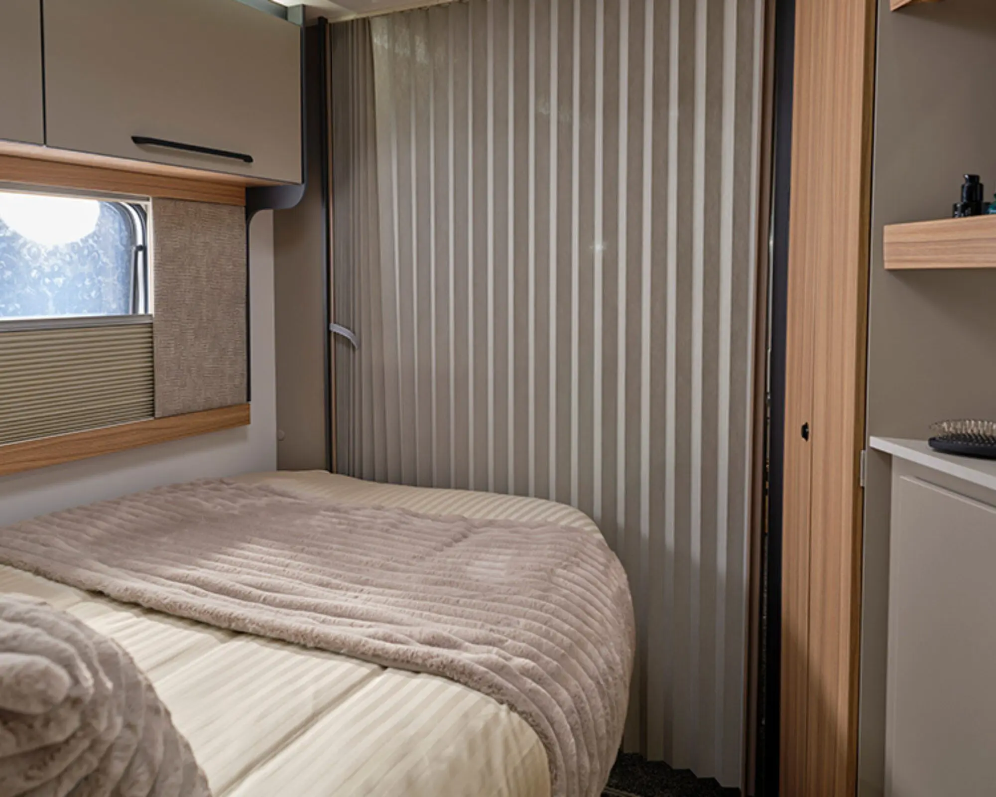 Convert your space into an en-suite bedroom with concertina partition screen separating the bedroom and front lounge