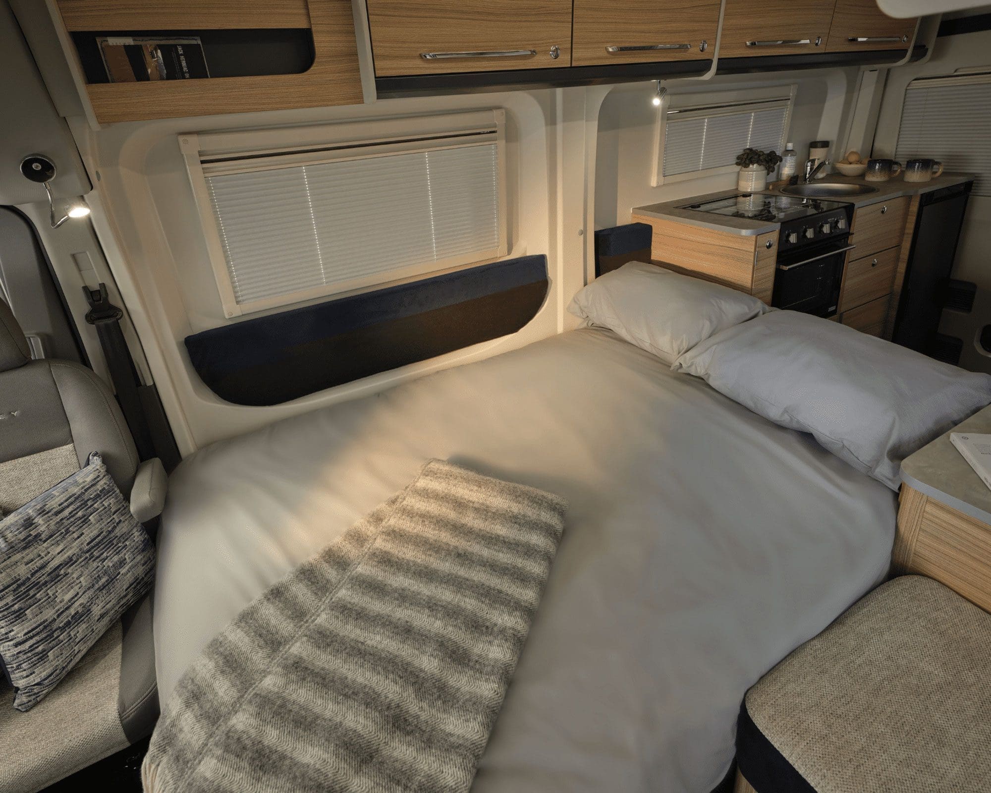 Cozy Interior of a Bailey Motorhome Bedroom Cozy bed area in a Bailey motorhome, featuring warm lighting and wooden accents.