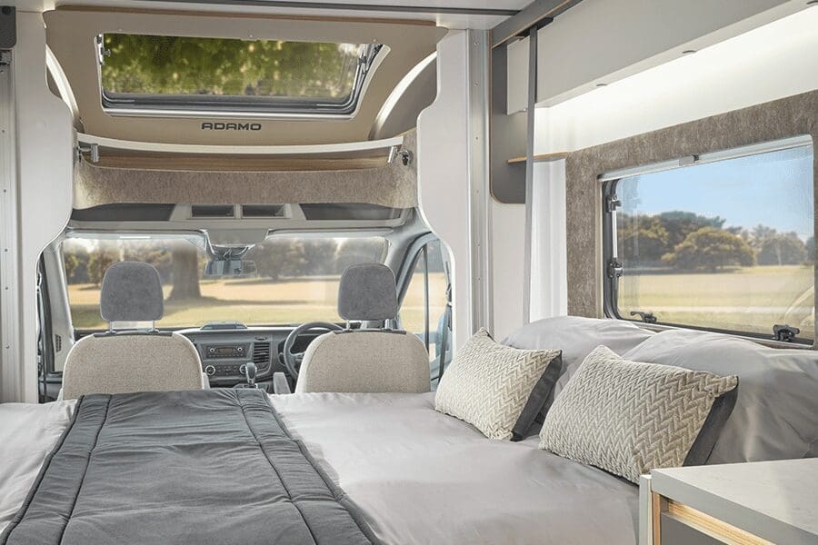 Cozy interior view of a Bailey motorhome featuring seating and a sleeping area, designed for comfort and adventure.
