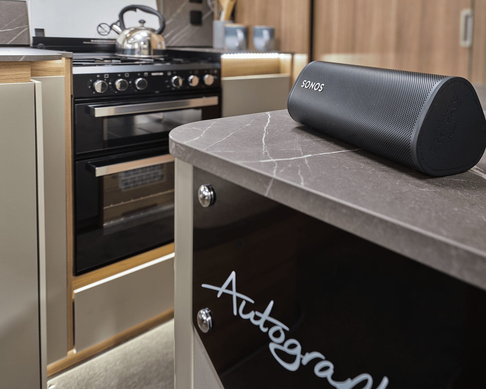 Interior view of a motorhome kitchen featuring a modern oven and sleek countertop design.