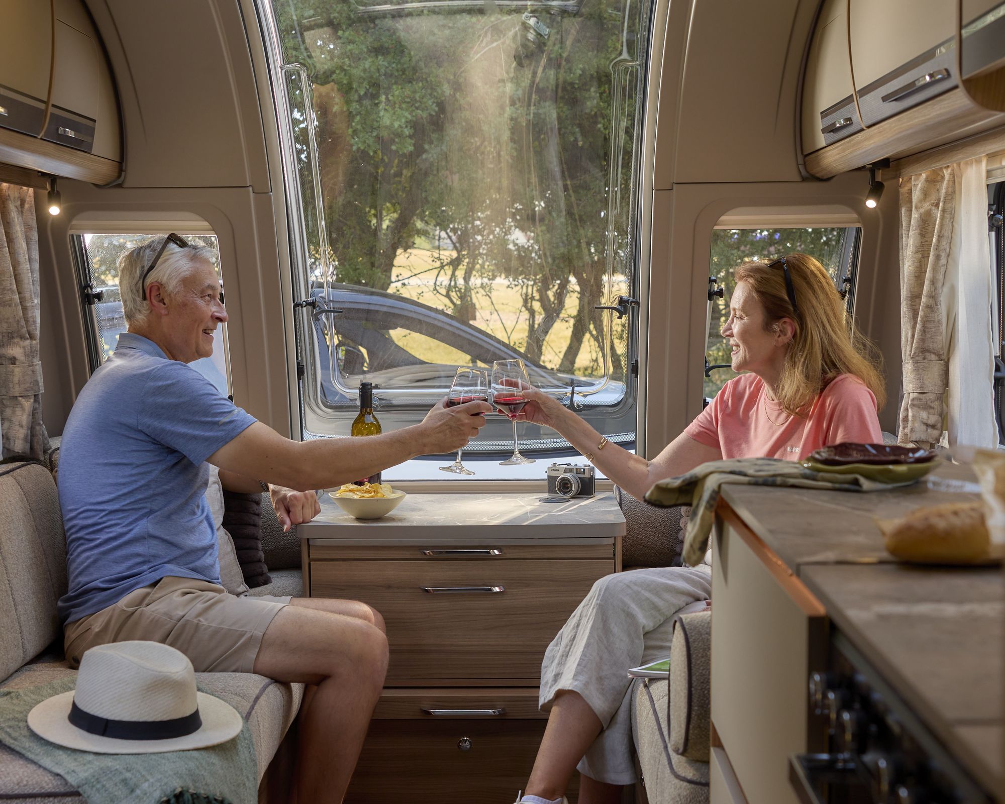 Couple enjoying a drink in the Bailey Unicorn Deluxe 2027 front lounge