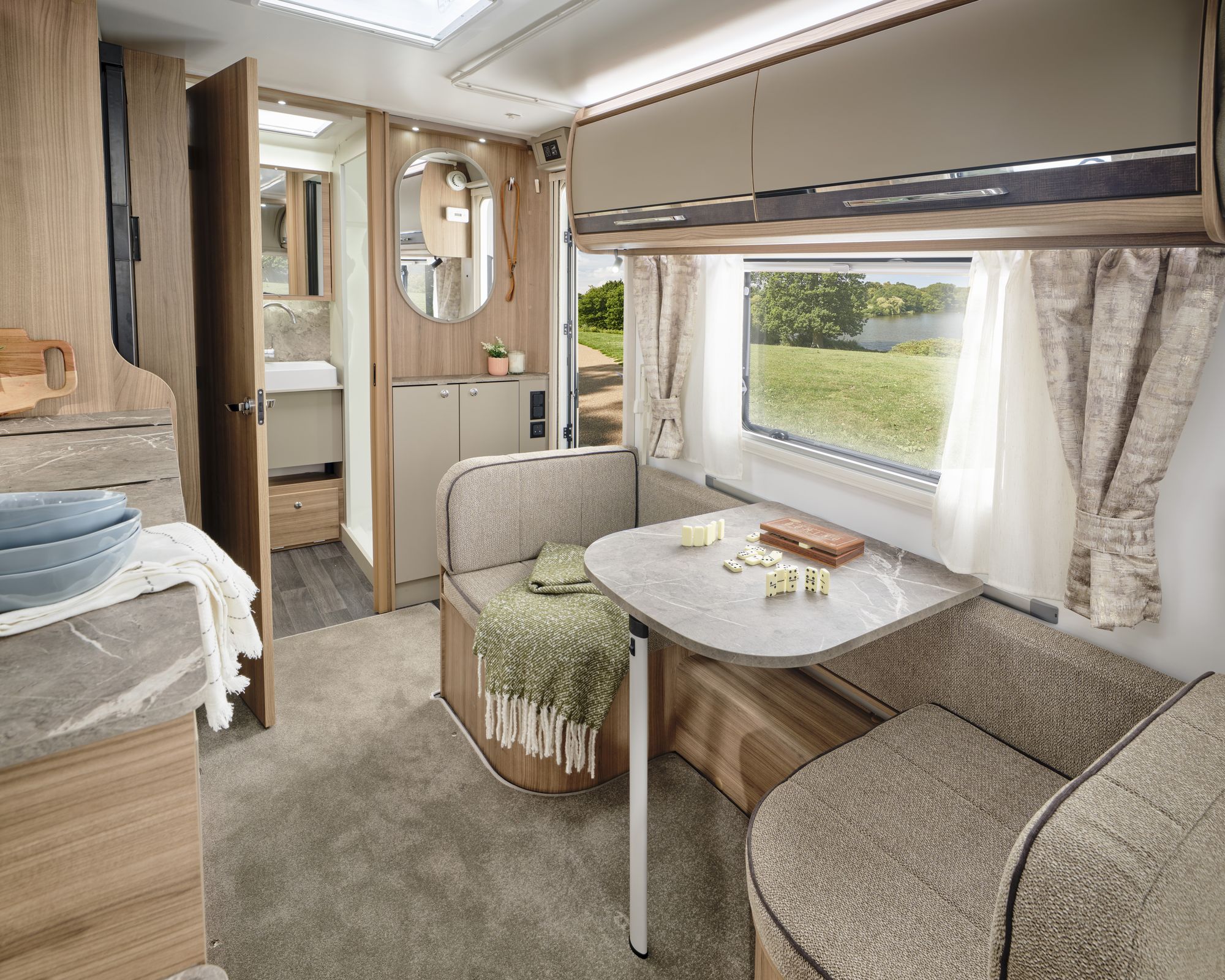 Side dinette and living area in the Bailey Unicorn Deluxe Madrid 2027