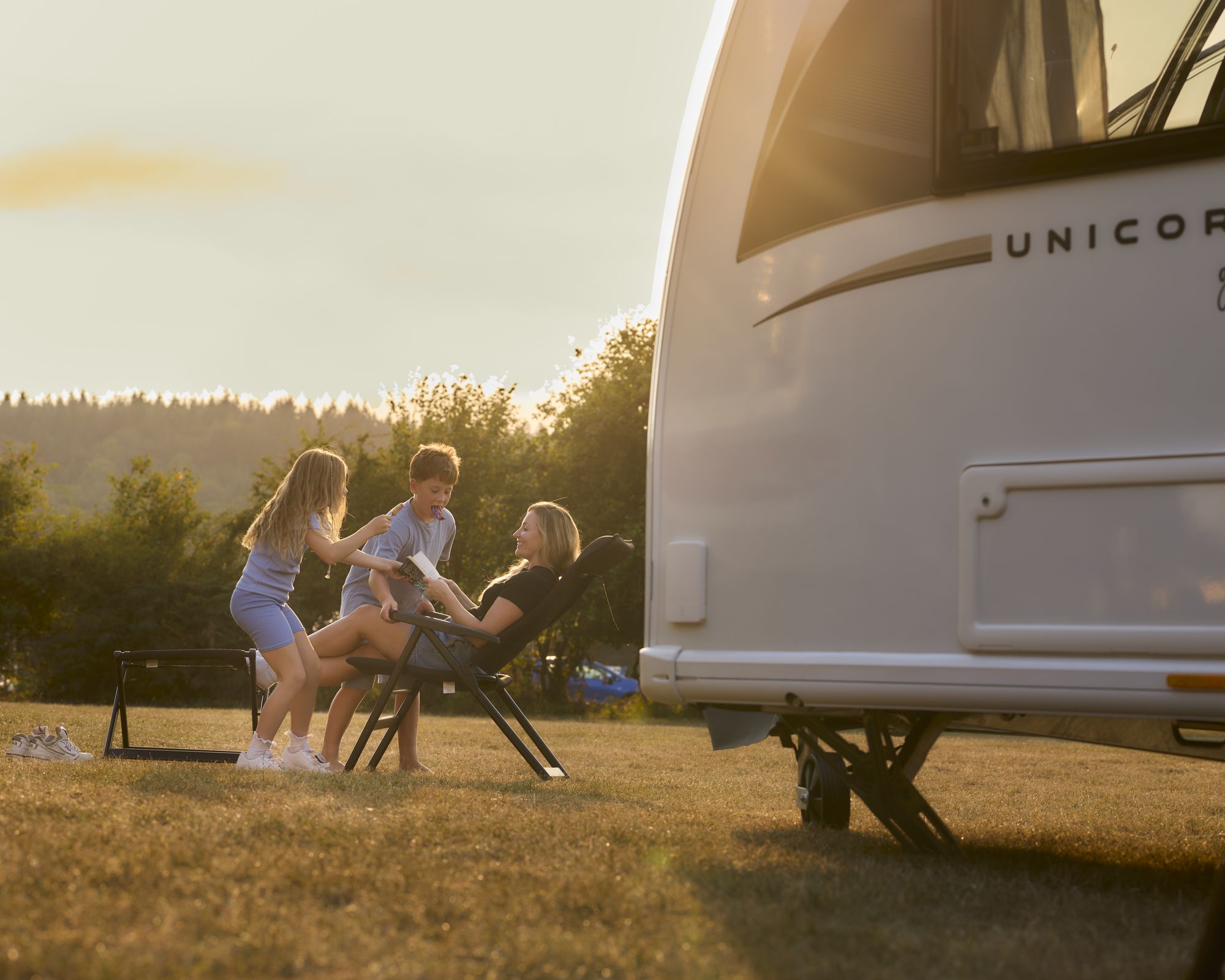 Family enjoying the outdoors beside a Bailey Unicorn Grande 2027